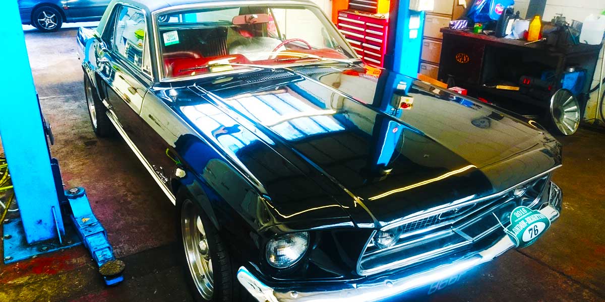 front corner on a ramp a very eye catching nineteen sixties american cadilac in fabulous condition with body to glass painted aqua blue and top to roof painted crisp white