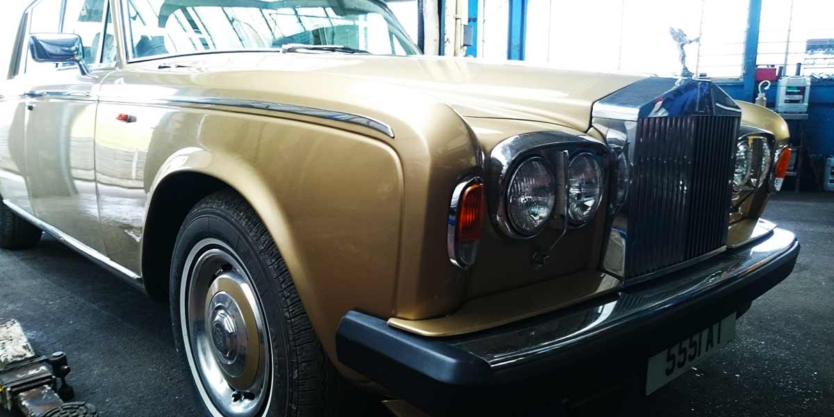 front corner view of a classic rolls royces silver shadow in for repairs to the engine and brakes