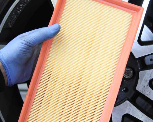close up of a new vauxhall air filter about to be fitted in a van