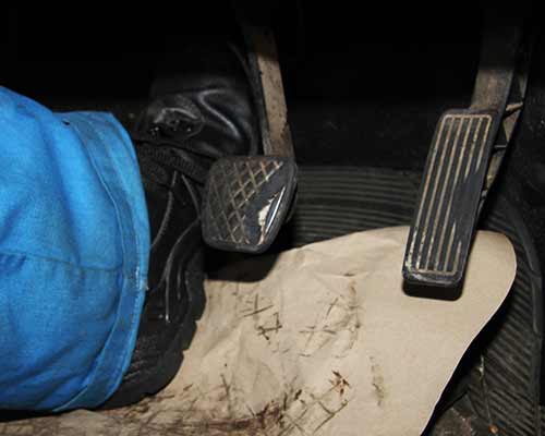 foot pressing a renault clutch pedal to the floor