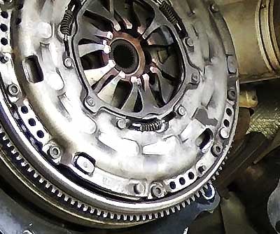 close up of a car engine in situation with no gearbox showing the vehicles clutch