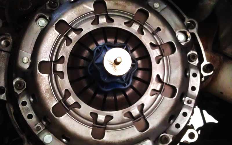 newly fitted clutch close up photographed from underneath with the cars gearbox still off