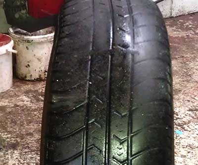 damaged and very badly worn tyre that has been illegal for some considerable time