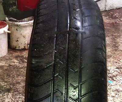 damaged and very badly worn tyre that has been illegal for some considerable time