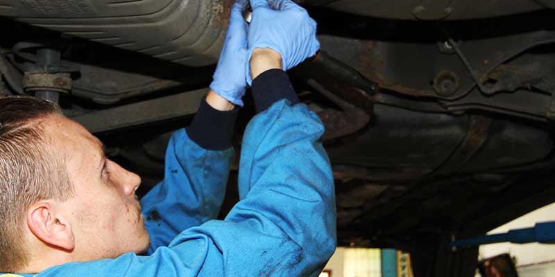 under vehicle close up of corroded fuel pipes in desperate need of repair