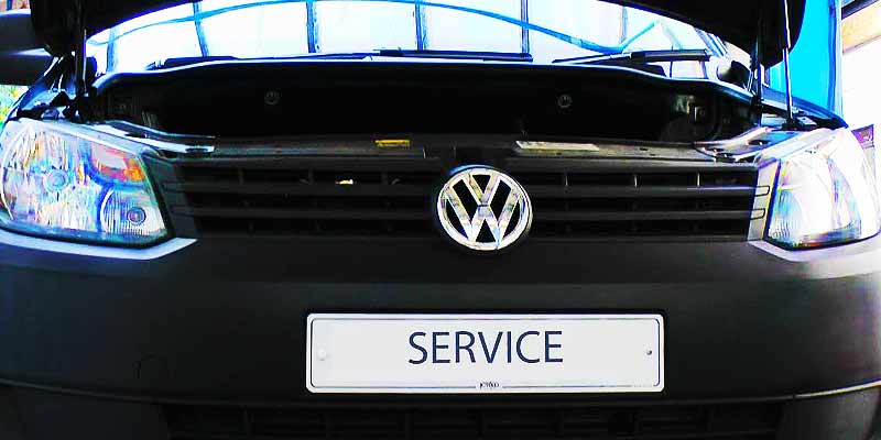 close up of a volkswagon car with bonnet up getting an annual vehicle service