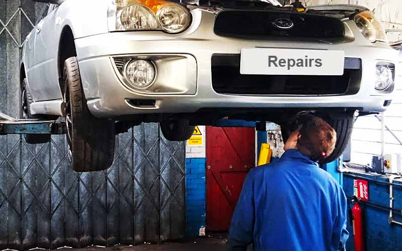 in for repairs a suburu car up high on a ramp in excels chesterfield garage