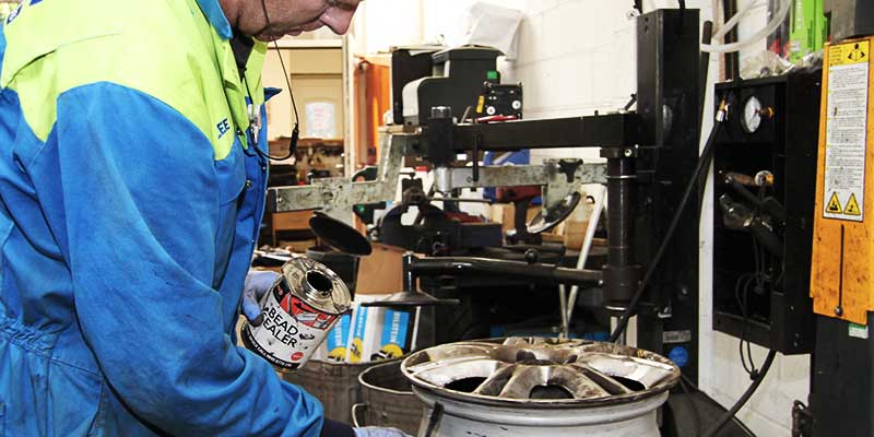 excel tyre fitter preparing a car rim to snuggly fit its new tyre