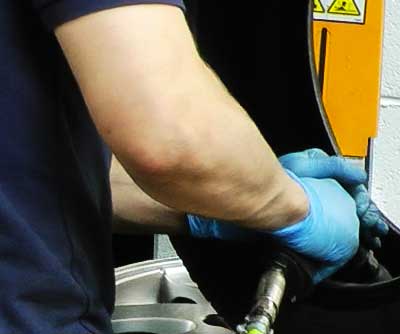 close up of a tyres inner surface being gently roughed with a specialists tyre scuffer