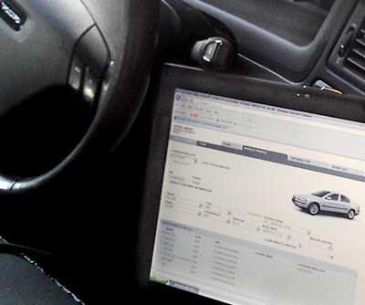 ciew through the drivers side window of a volvo car having its computer sytems scanned for errors