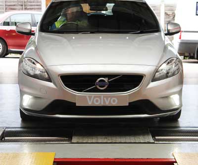 a modern volvo on brake testing rollers analysing braking performance